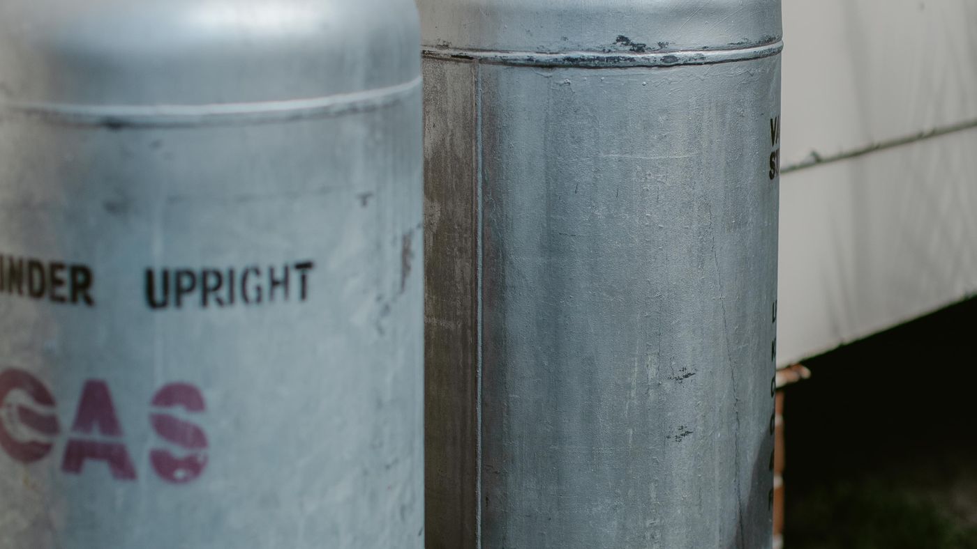 LPG cylinders installed against a house