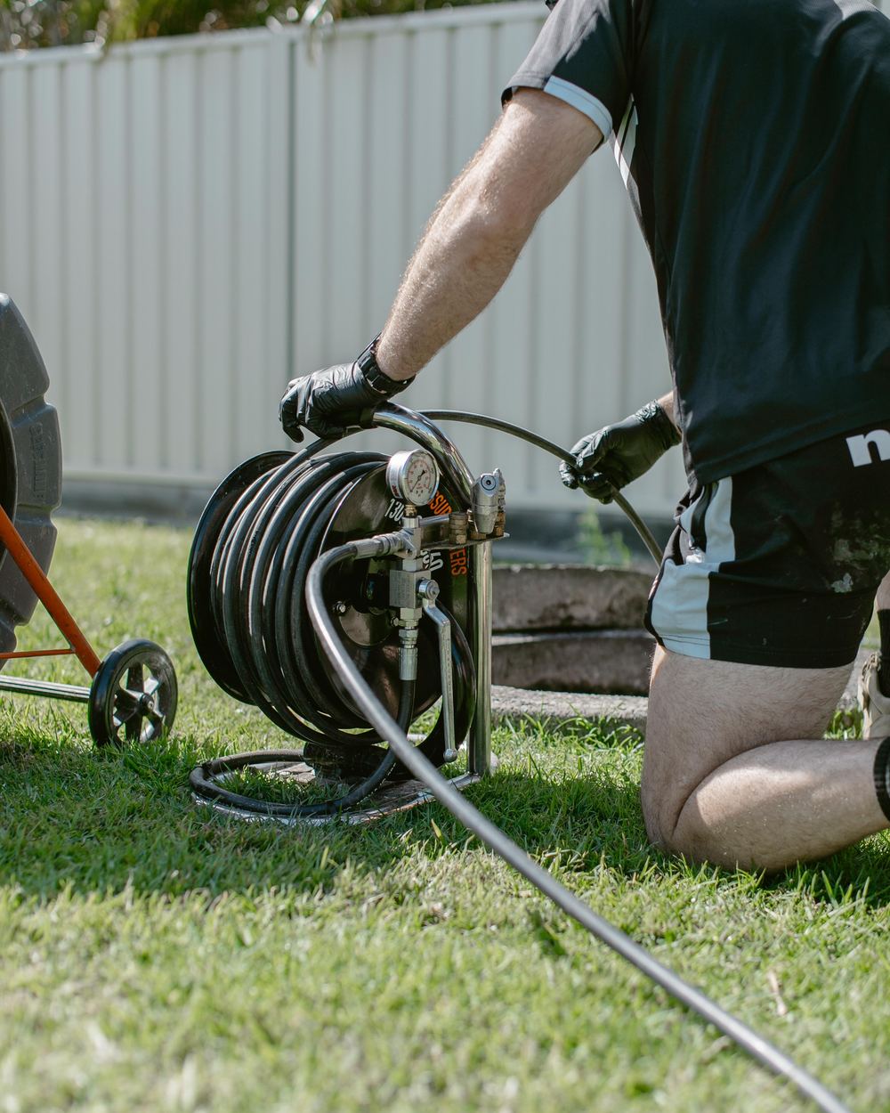 Plumber setting up drain jetting equipment