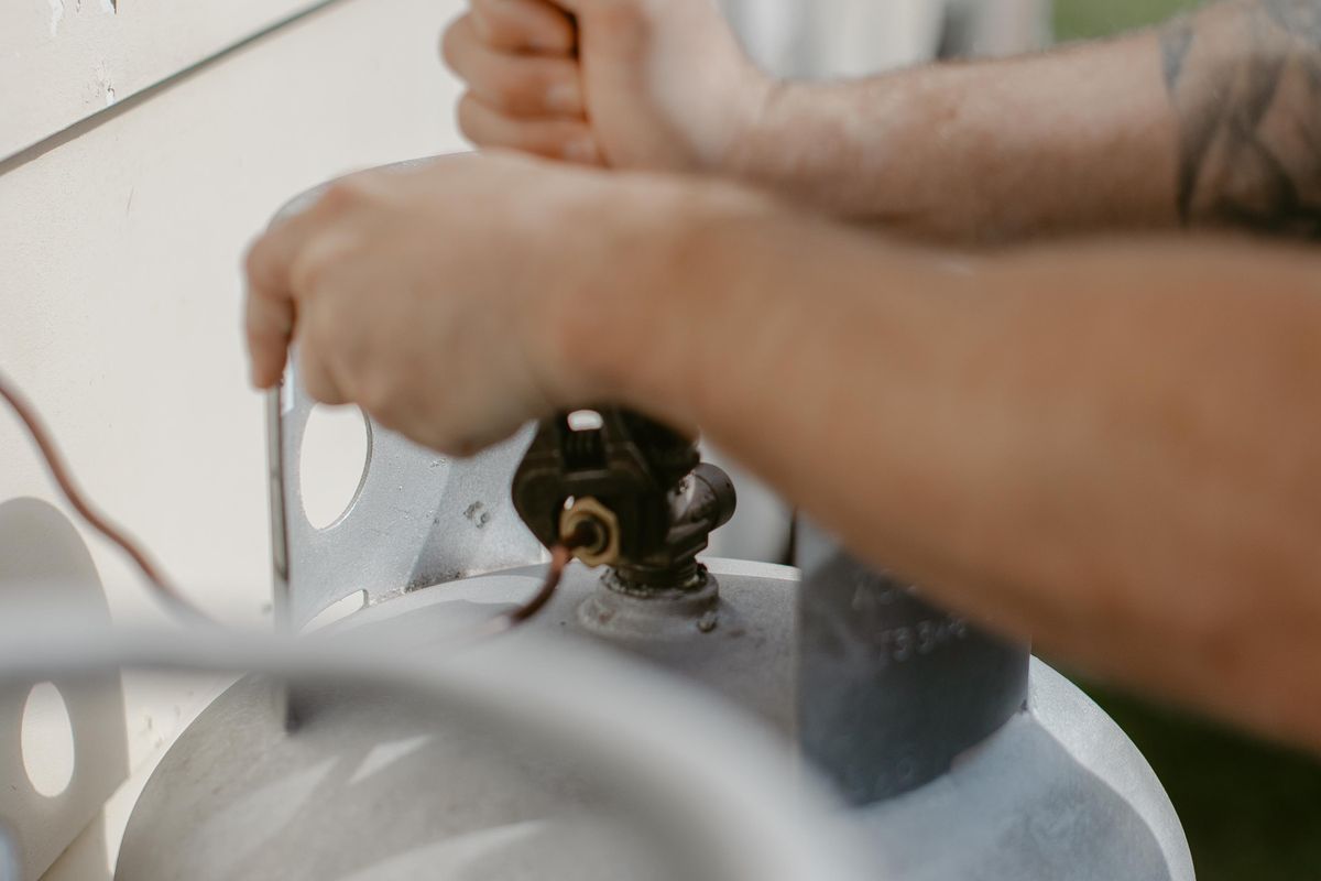 Gas cylinder regulator being serviced