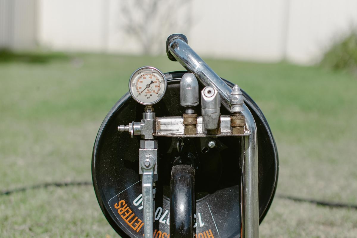 High pressure jetting hose feeding into a drain